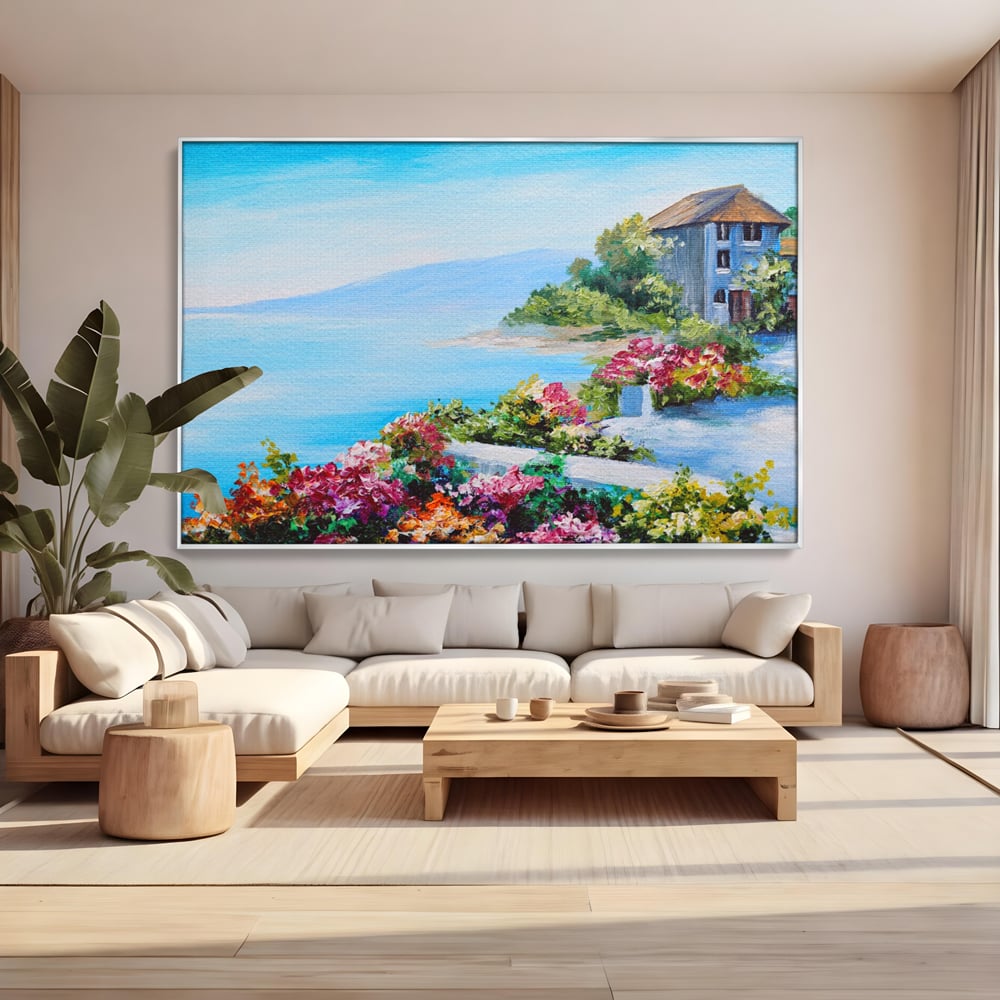 Tablou canvas cu tablou pictura cu flori si mare, in rama de aluminiu argintiu, pe perete intr-un living